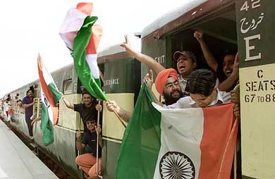 Indian cricket fans wave the Tricolour on their arrival at Lahore railway station on Saturday