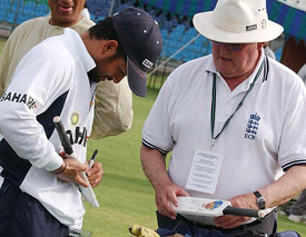Sachin Tendulkar signs an autograph for umpire David Shepherd during a training session in Lahore