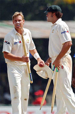 Shane Warne and Andrew Symonds walk back to the pavilion after Australia beat Sri Lankan by 27 runs