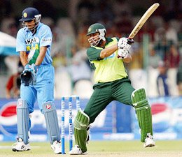 Pakistani captain Inzamam-ul Haq hits a shot as Indian wicketkeeper Rahul Dravid looks on 