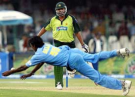 Lakshmipati Balaji makes a valiant attempt to stop a drive by Pakistani skipper Inzamam-ul-Haq off his own bowling during the fourth ODI