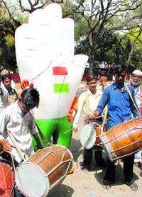 Congress activists celebrating outside AICC office in the Capital on Monday.