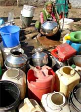 Even as the world observed World Water Day, an elderly woman fills her pitcher after waiting in a long queue on the outskirts of Bhopal on Monday