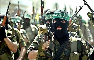 Armed Hamas militiamen attend the funeral of Hamas leader Sheikh Ahmed Yassin in Gaza Strip on Monday