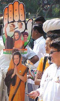 A vendor sells Congress merchandise featuring images of Ms Sonia Gandhi outside the party headquarters in New Delhi on Tuesday. 