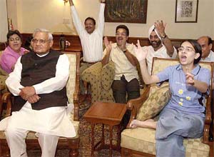 Prime Minister A.B. Vajpayee, along with his foster daughter Namita and granddaughter Neha, watches the 5th and final India-Pakistan one-day international cricket match on TV at his residence in New Delhi