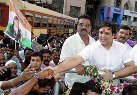 Bollywood star Govinda shakes hands with supporters as he begins his election campaign