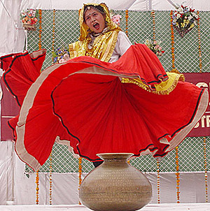 A girl student performs during the annual prize distribution function