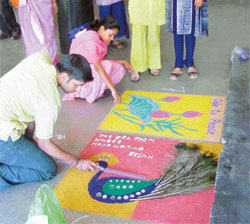 Students take part in a rangoli competition during Anjuman 2004 at PAU