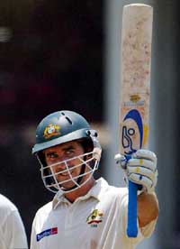 Australia's Justin Langer celebrates his century during the fourth day of the third Test