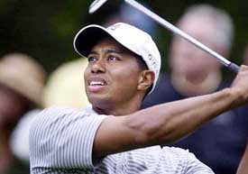 Tiger Woods from the U.S. watches his tee shot on the 8th hole during the second round of the Players Championship