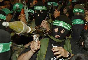 Masked Hamas militants march in an anti-U.S. and Israel rally in the town of Sheikh Radwan