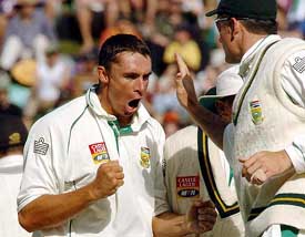 South Africa's Andre Nel celebrates with his captain Graeme Smith after taking the wicket of New Zealand skipper Stephen Fleming