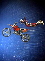 Nick Franklin of New Zealand performs a daredevil stunt with his motorbike 