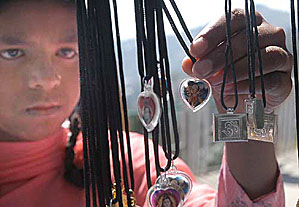 A girl selects a pendant at Kali-Bari Temple in Shimla on the occasion of Ashtami on Monday.