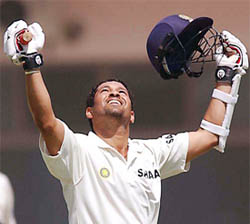 Master blaster Sachin Tendulkar lifts his bat after completing his century on the second day of first Test against Pakistan 