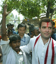 Rahul Gandhi walks with a supporter