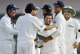 Sachin Tendulkar celebrates with teammates after taking Moin Khan's wicket during the third day's play in the first Test in Multan 