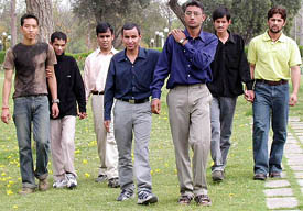 Amar (extreme left), Tarun (in the middle with glasses) and Rajiv (extreme right) lends a helping hand to the visually challenged students