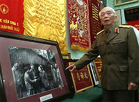 Vietnamese General Vo Nguyen Giap points at a photograph taken during his visit to a military base in Quang Binh province