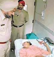 Mr Bhupinder Singh, SHO, Phase I, records the statement of Beant Kaur, alias Asha, at a hospital. Asha jumped from the third floor of a building to evade her creditors in Mohali on Thursday. 