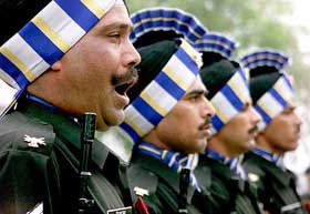 Soldiers from 53rd Armoured Regiment take part in a march past 