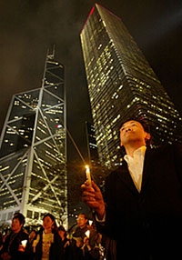 Pro-democracy protesters hold a candlelit vigil at Hong Kong�s financial central district on Thursday. Hundreds staged protests to condemn Beijing�s imminent review of the local constitution. 