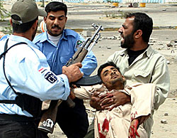 A badly wounded protester is carried away after clashes between jobless protesters and Iraqi police broke out in the southern city of Basra on Thursday. 