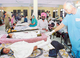 A doctor examines a polio patient at a camp held at Satya Narayan Mandir in Sector 22, Chandigarh, on Friday.