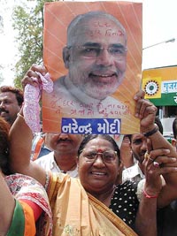 A woman activist demonstrates against Gujarat Chief Minister Narendra Modi for his alleged remarks on Congress President Sonia Gandhi and her son, Rahul, during a protest rally in Ahmedabad on Friday. 