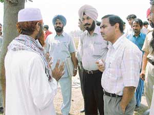 SDM Prem Chand talks to villagers in Seera village near Ludhiana, on Friday.
