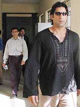 Wasim Akram, former captain of the Pakistan cricket team, leaves the court building after hearing in Karachi