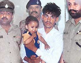 Ram Lakhan Yadav, who was arrested in Sonepat by the Chandigarh police for allegedly kidnapping a child, Deepak (seen in his lap), from Kajheri village in Chandigarh. 