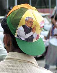 A supporter of BJP in party headgear in the Capital on Saturday. 