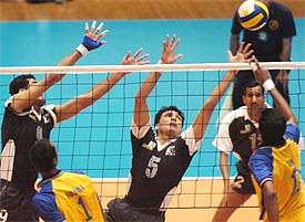 India�s Tom Joseph hits a ball over the net and Pakistan�s Muhammad Tufail puts up a defence during the volleyball final in Islamabad