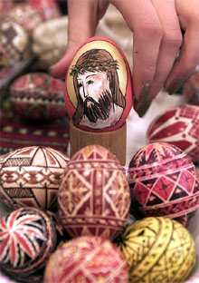 A woman arranges a traditional Orthodox Easter egg