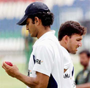 Irfan Pathan and Ajit Agarkar prepare to bowl at the nets in Lahore