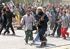 Crowds of protesters, including members of Mehdi Army, a banned Iraqi militia, march on a Spanish garrison in the holy city of Najaf 