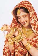 A model displays designs in traditional and contemporary gold jewellery.