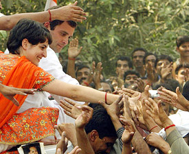 Priyanka Vadhra and Rahul Gandhi shake hands with the crowd during an election campaign in Sultanpur