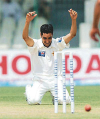 Pakistani fast bowler Umar Gul kneels down to kiss the ground after he took his fifth wicket 