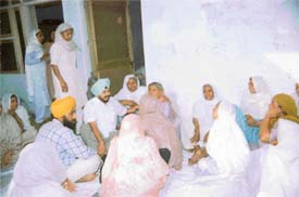 Mr Sadhu Singh Dharamsot, MLA, Amloh, expresses his condolences with the families of the three victims who were shot by an ex-serviceman at Jhambala village 