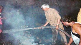 Firemen douse the flames after a fire broke out in a slum cluster near New Sabzi Mandi in Ludhiana