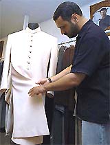 Famous Pakistani dress designer Amir Adnan checks a Sherwani that he tailored for Indian Prime Minister Atal Bihari Vajpayee