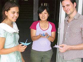 Olga Walles from the Netherlands (extreme left) learns the art of paper folding from her Japanese friend Kazuno (centre), while Wilco, another student from the Netherlands splashes a warm smile