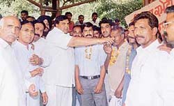 Congress legislator Surinder Dawar offers fruit juice to MC employees who ended their hunger strike in Ludhiana on Wednesday.
