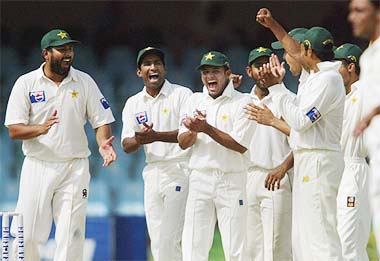 Pakistani players celebrate the dismissal of Rahul Dravid on the third day of the second Test in Lahore