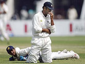 Rahul Dravid and Parthiv Patel react after failing to take a catch of Pakistani batsman Asim Kamal 