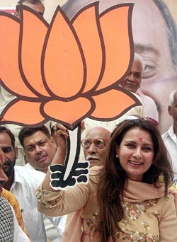 Veteran Bollywood actress Poonam Dhillon holds BJP election symbol at an election campaign rally