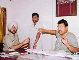 The DSP, Mr R.K. Bakshi, and the SHO, Focal Point, Mr Surinder Mohan, with murder accused Anil Kumar, a labourer